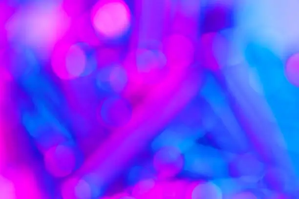 Photo of Bokeh with multi colors dots. Festive blue lights bokeh background. Defocused bokeh lights. Blurred bokeh. Light vintage background. Abstract colorful defocused pink dot. Soft focus