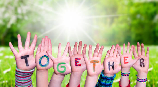 istock Children Hands Building Word Together, Grass Meadow 1214026927