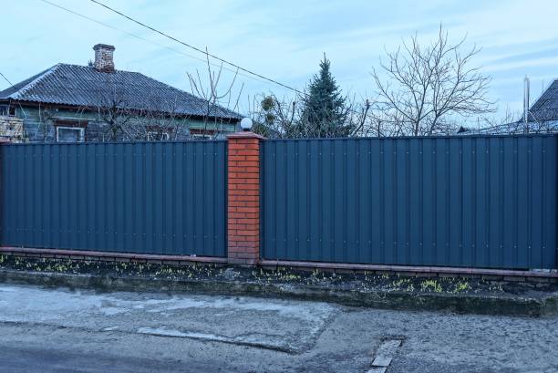 istock metal and red brick evening wall fence 1214027863
