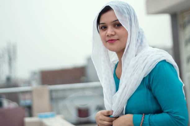 istock Beautiful woman is drinking coffee on the home rooftop 1214027880