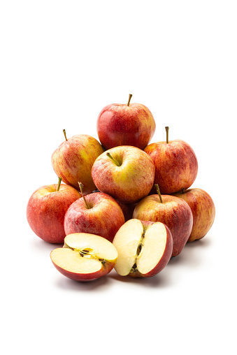 Pile of Fresh Apples on white background. One apple sliced.