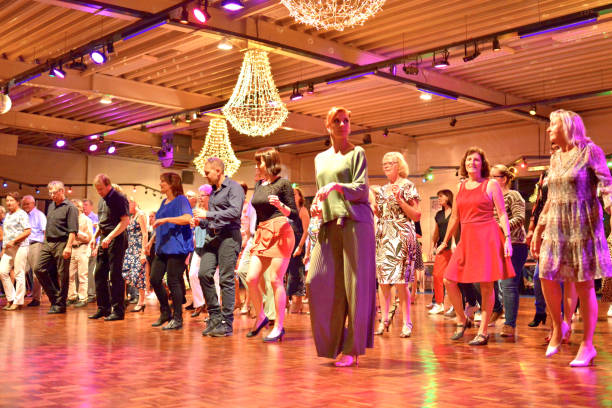 Workshop classes. Indoor line dancing by a professional instructor. Herent, Belgium - September 14, 2019: Open House indoor dancing classes evening show. Photo reportage open door promotion indoor dance classes. Courses starting half September. Teacher in front of group demonstrates solo dance. teacher retirement party stock pictures, royalty-free photos & images