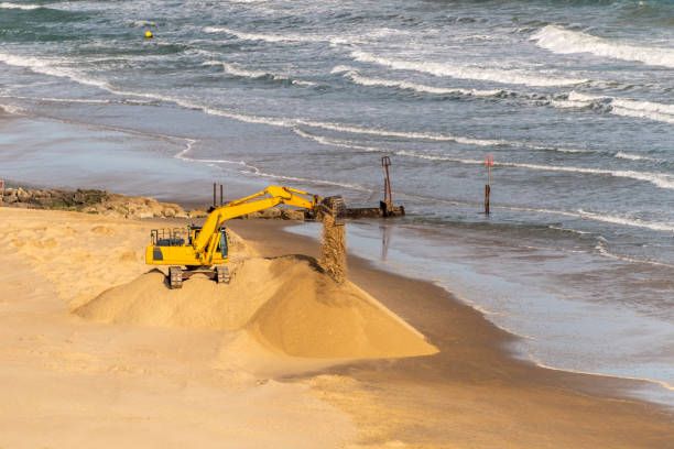 istock Digger replenishing sand on Bournemouth beach sea defences 1214029562