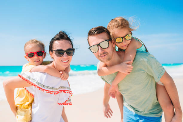 istock Young family with two kids on beach vacation 1214030828