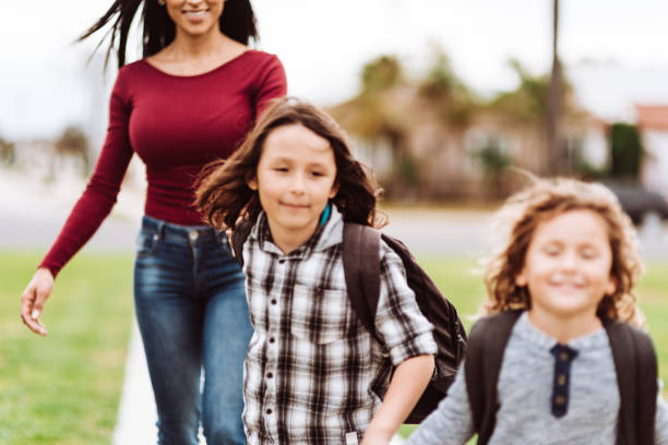 istock mother carrying the sons at school 1214033256