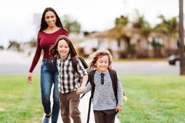 istock mother carrying the sons at school 1214033373