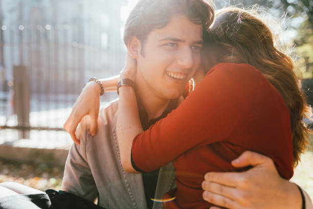 istock young couple in love outdoors hugging back light 1214034699