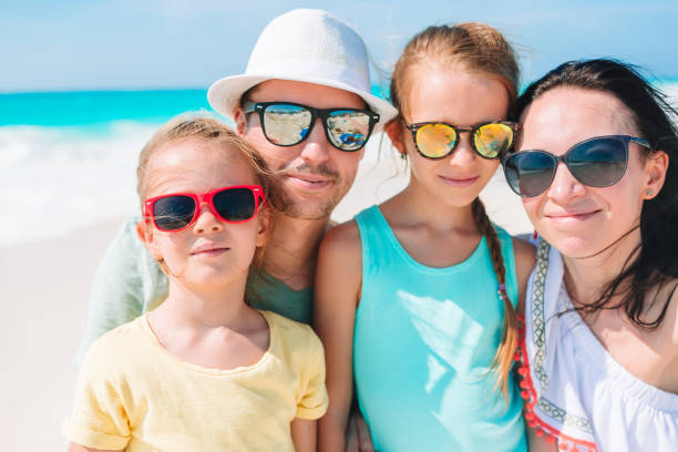 istock Happy beautiful family on white beach having fun 1214037378