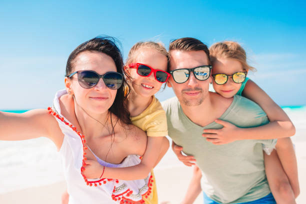 istock Happy beautiful family on white beach having fun 1214037401