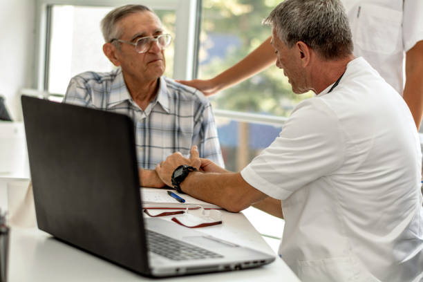 istock Doctor holding an old man's hand 1214037545