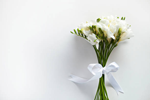 istock Minimalistic composition with tender spring time freesia flower on bright background. 1214039425