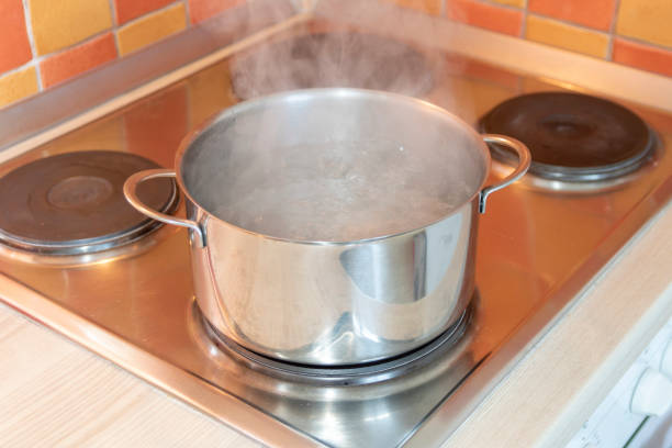 istock Pot with boiling water on an electric stove 1214039529