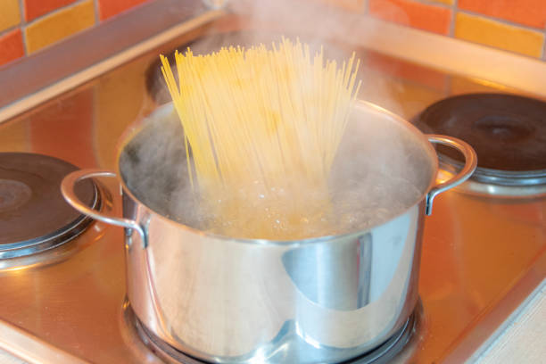 istock Spaghetti cooking in a stainles steel pot 1214039543