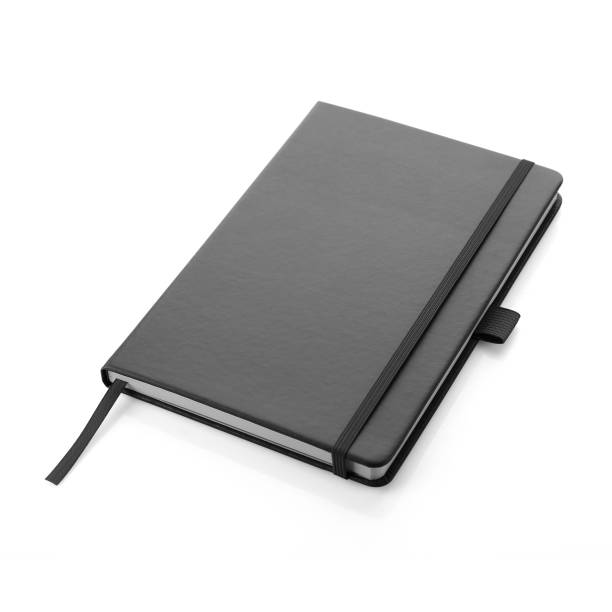 Black colour leather fabric hardcover notebook with elastic band lay back on white surface. Top view with notebook closed. Isolated on white background. For mockup, branding & advertising. No People moleskin stock pictures, royalty-free photos & images
