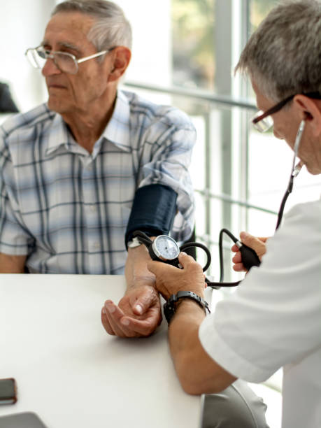 istock Doctor taking senior man's blood pressure 1214040423
