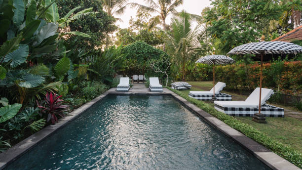 istock Swimming pool with lounge chair outdoors at sunny day 1214041746