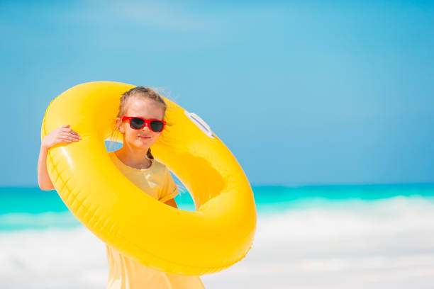 istock Adorable little girl having fun on the beach 1214042119