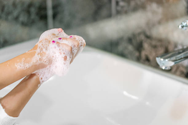 istock Little girl washing hands 1214042219