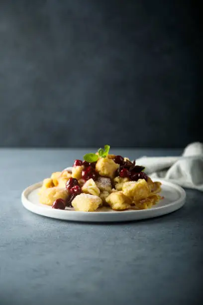 Traditional Austrian pancake dessert with cherry sauce