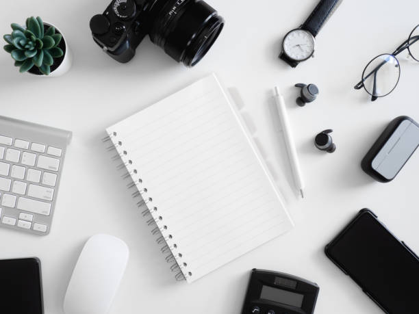 istock top view of work from home concept with calculator, notebook, plastic plant, smartphone and keyboard on white background, graphic designer, Creative Designer concept. 1214043253