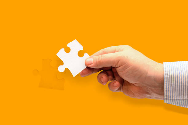 istock hand holding piece of jigsaw puzzle 1214043808