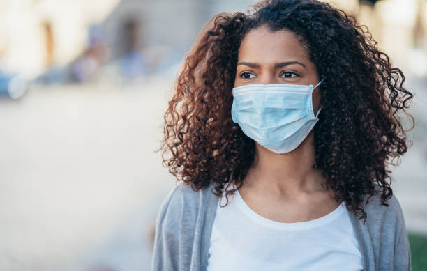 istock Woman with face protective mask 1214048041
