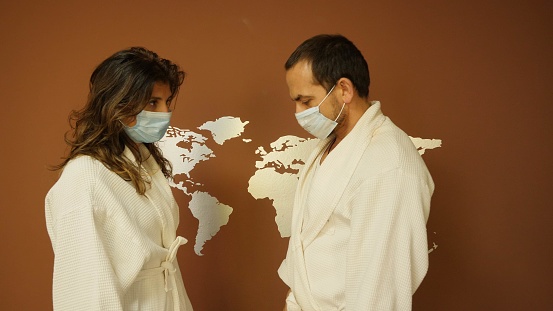 During the Corona Virus epidemy in March 2020 a couple in Germany stay at home and wear masks to protect themselves from getting infected