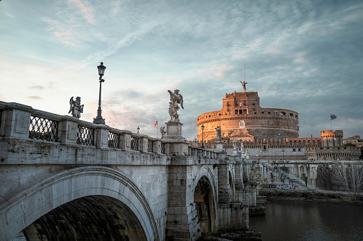 View of Castel Sant'Angelo and Tiber River at sunset. Horizontal composition.
