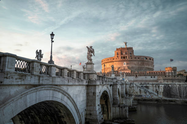 View of Castel Sant'Angelo and Tiber River at sunset stock photo