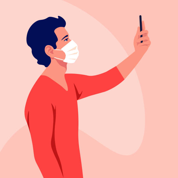 stockillustraties, clipart, cartoons en iconen met een jonge man draagt een medisch masker neemt een selfie en houdt smartphone in zijn hand. coronavirus. een blogger. epidemie en pandemie. - man met mondkapje