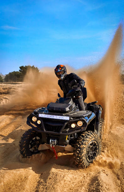 istock Racing in the sand on a four-wheel drive quad. 1214050083