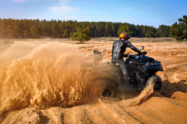 istock Racing in the sand on a four-wheel drive quad. 1214050094