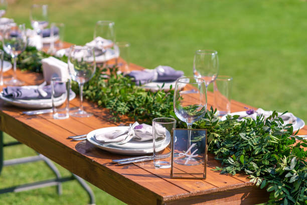 istock Preparing for an open-air party. Decorated with fresh flowers served tables. Table number. Decoration Details 1214050178