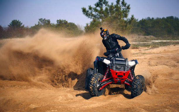 istock Racing in the sand on a four-wheel drive quad. 1214050937
