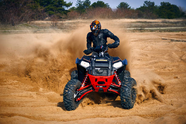 istock Racing in the sand on a four-wheel drive quad. 1214050938