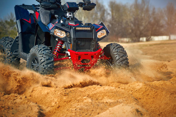 istock Racing in the sand on a four-wheel drive quad. 1214050948