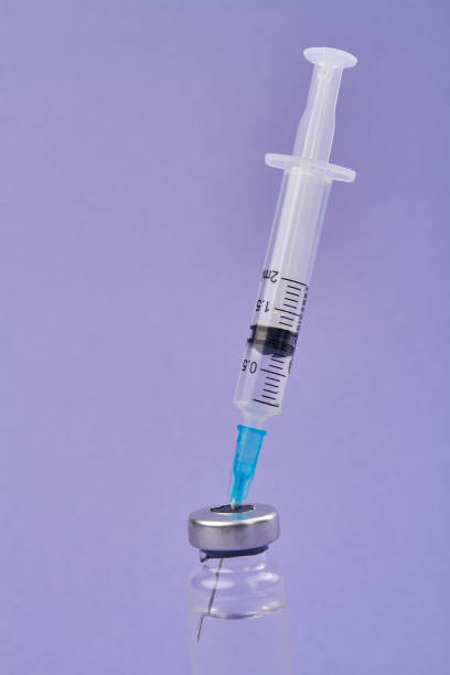 istock Syringe sticks from the vial bottle. 1214051226
