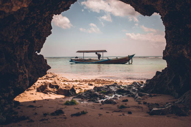 Beautiful tropical landscape, white sand, blue sea and traditional boat. Travel to Southeast Asia