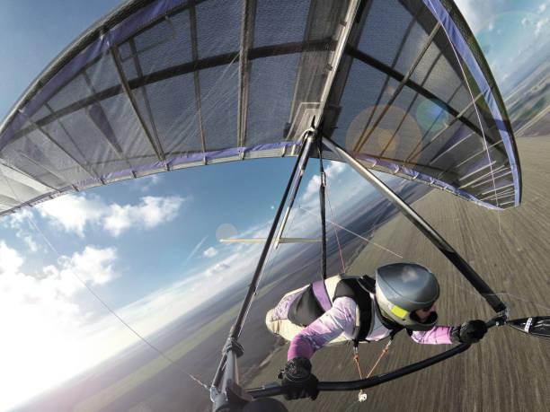 istock Hang glider pilot fly like a bird above ground. Extreme sport. 1214051705