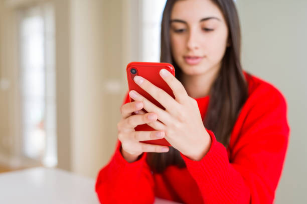 istock Young woman using smartphone, smiling happy texting and typing 1214052443