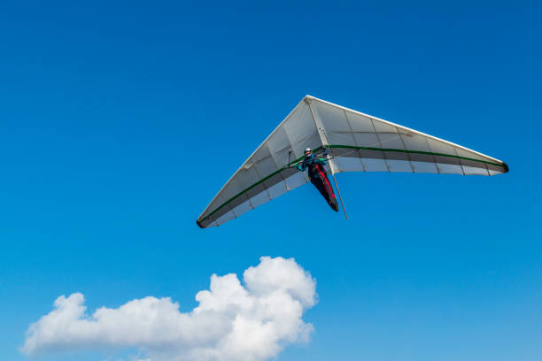 Hang glider wing and blu sky with white cloud. Dream of flying come true. Hang glider wing and blu sky with white cloud. Dream of flying come true. glider hang glider hanging sky stock pictures, royalty-free photos & images