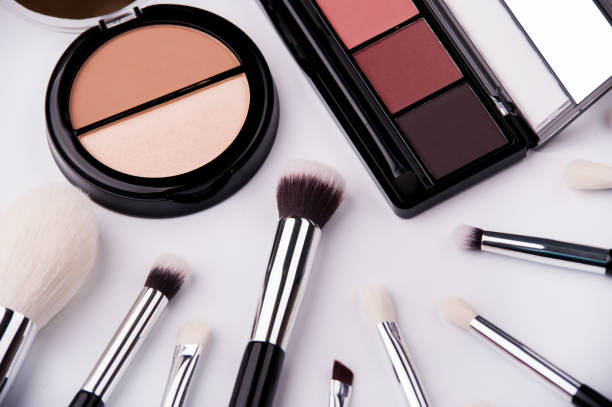 istock Cosmetic palette and face shadow with brushes lies on white background 1214053592