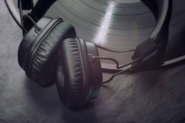 istock Over or on-ear headphones on vinyl record. 1214053598