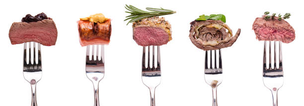 istock Meat venison lamb beef roulade and sausage on a fork white isolated 1214055221