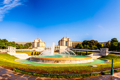 Fountain in Trocadero garden with the Palais of Chaillot in background near Eiffel Tower in Paris, France.