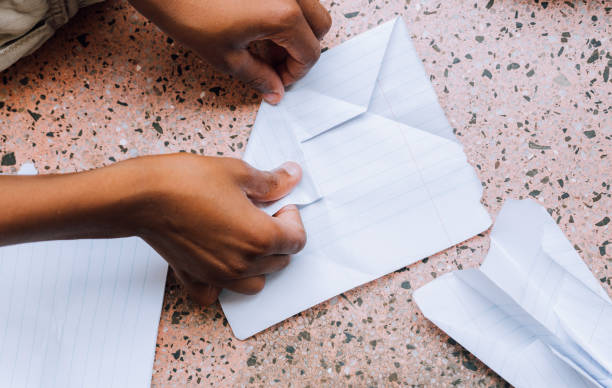istock African boys building paper airplanes 1214056591