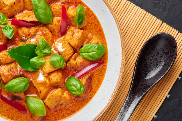 istock Thai Panang Chicken Curry in white plate. Phanaeng Curry is thai cuisine dish with chicken, kaffir lime leaves, red curry sauce and vegetables. Thai food. Thailand meal. Close up 1214059009