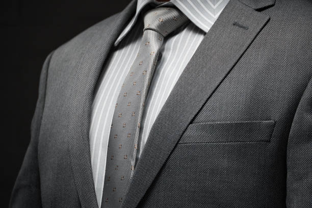 istock businessman portrait dressed in gray suit, dark wall background 1214059551