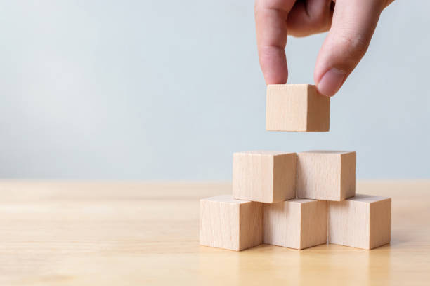 istock Hand arranging wood block stacking as step stair. Business concept for growth success process 1214059696