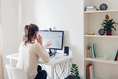 Work from home during coromavirus pandemic. Woman stays home. Workspace of freelancer. Office interior with computer